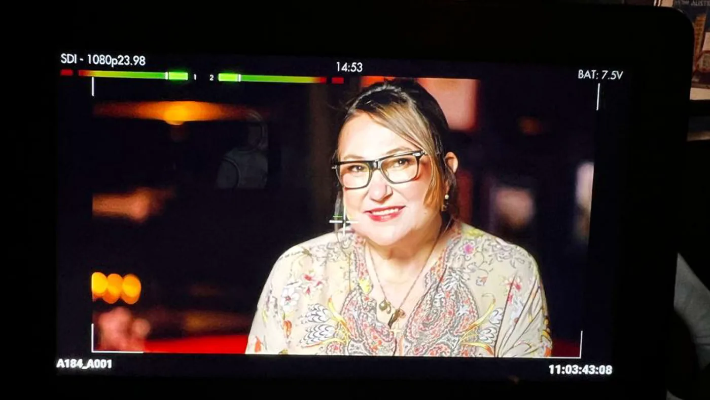Miche Bonett on set, seen through a camera monitor